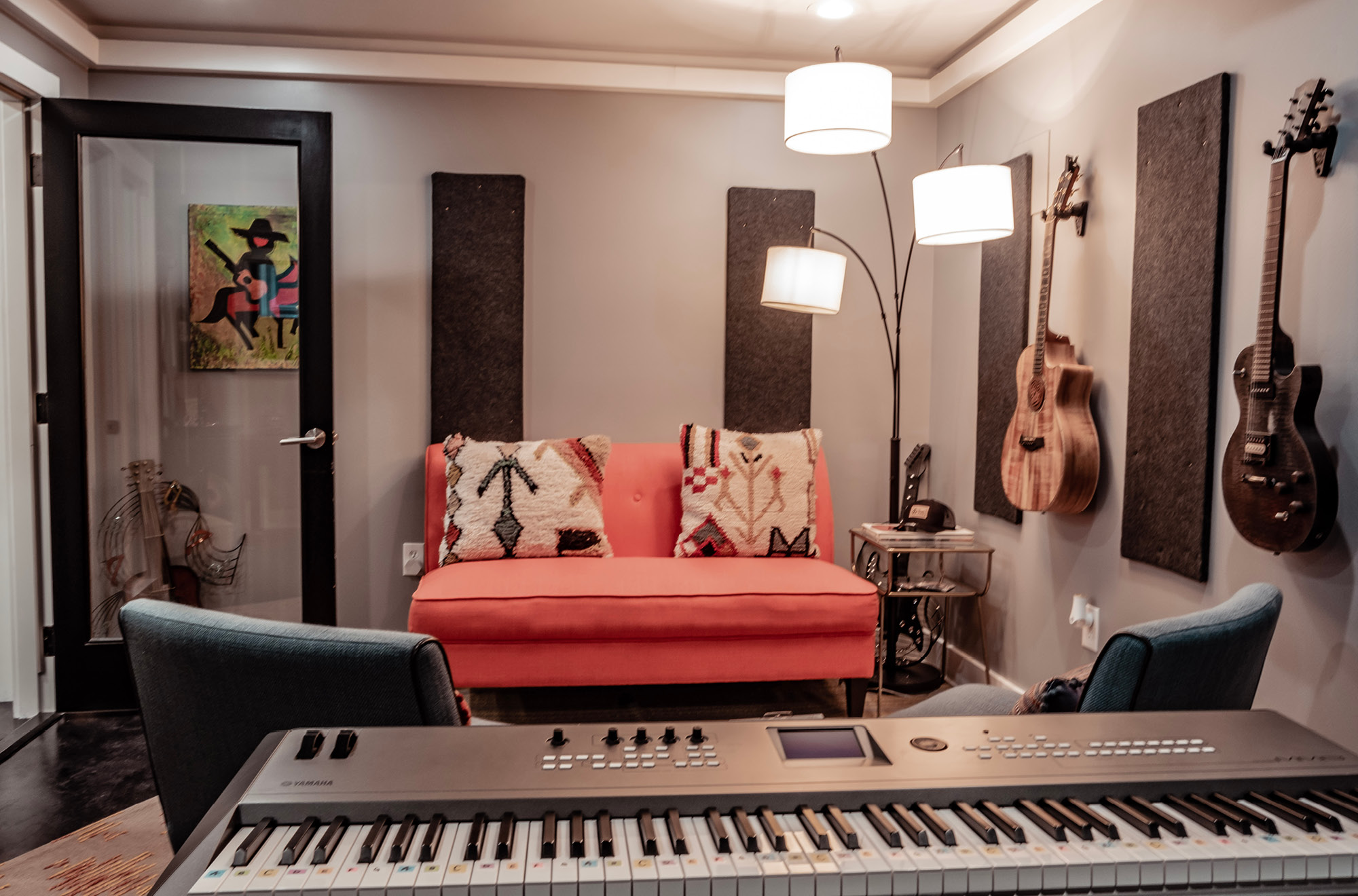 One of our writers rooms, equipped with a keyboard, guitars, and comfortable seating