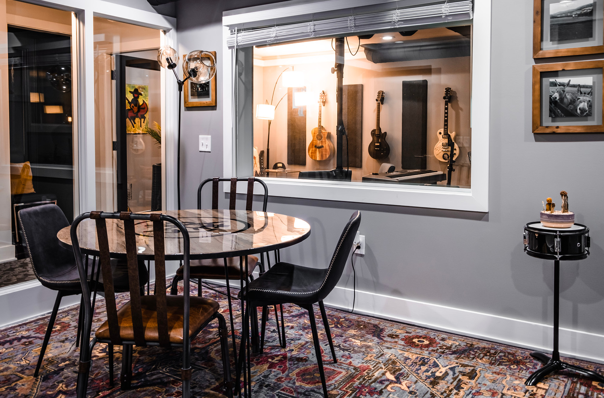 A table and chairs with the NashVilla logo in the middle of a warm writing room